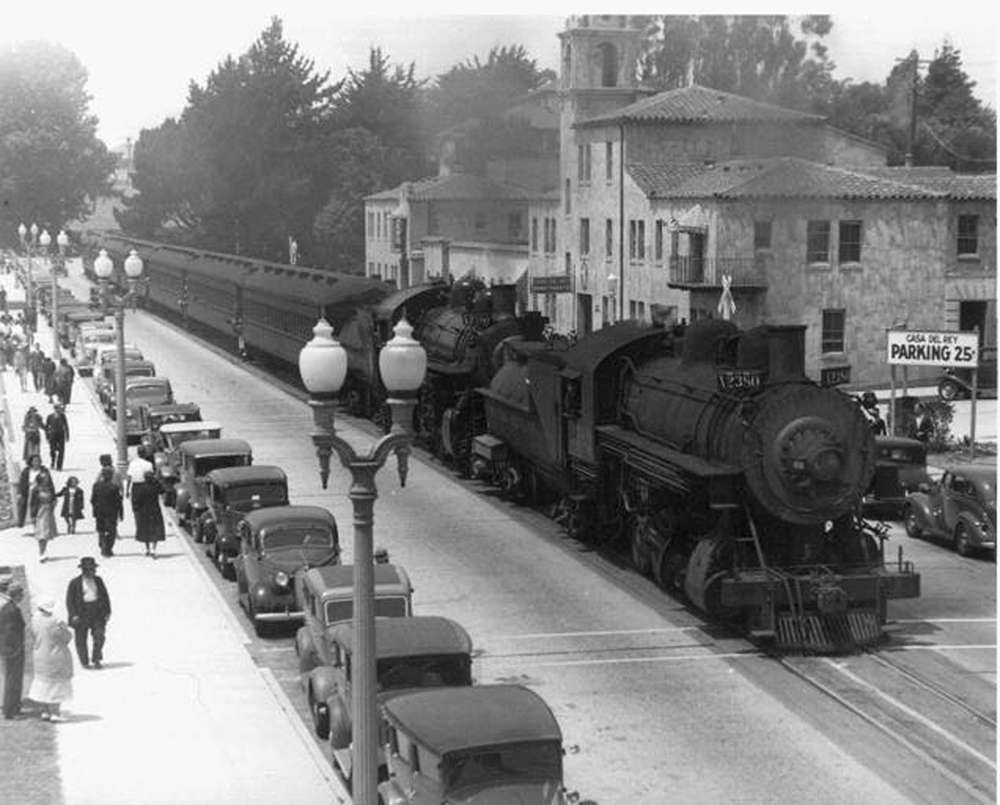 black and white train coming through town