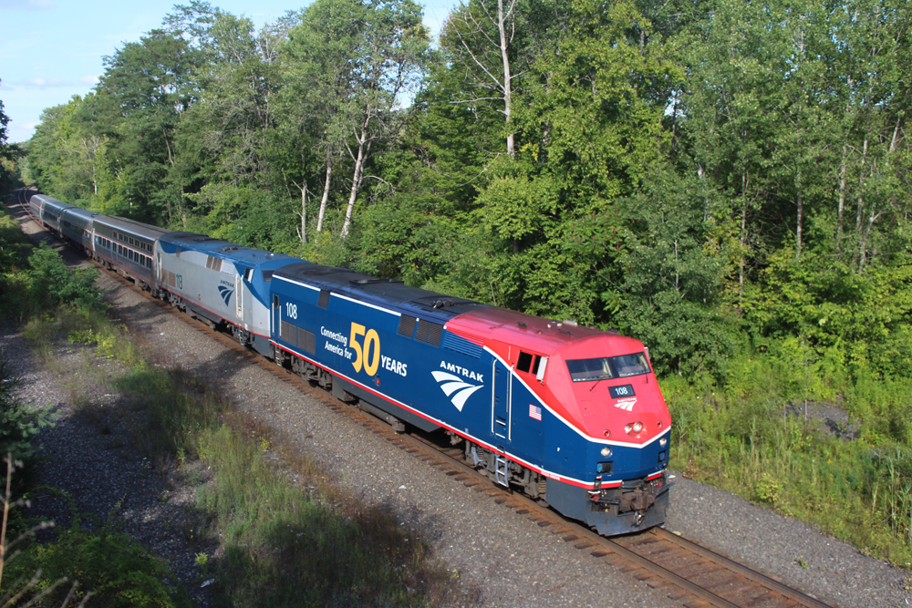 Red and blue locomotive on passenger train
