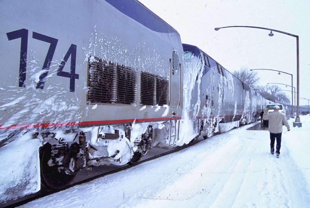 Train at station stop in heavy snow