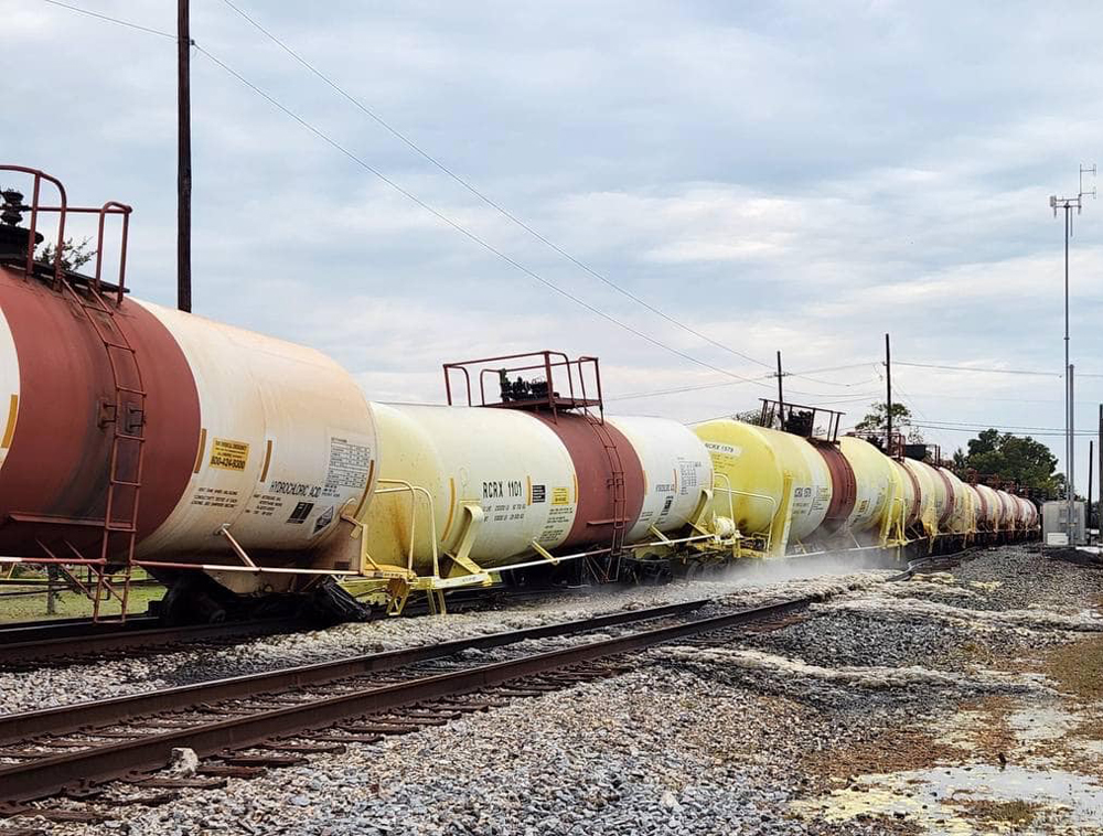 Tank cars off track with material leaking from one car