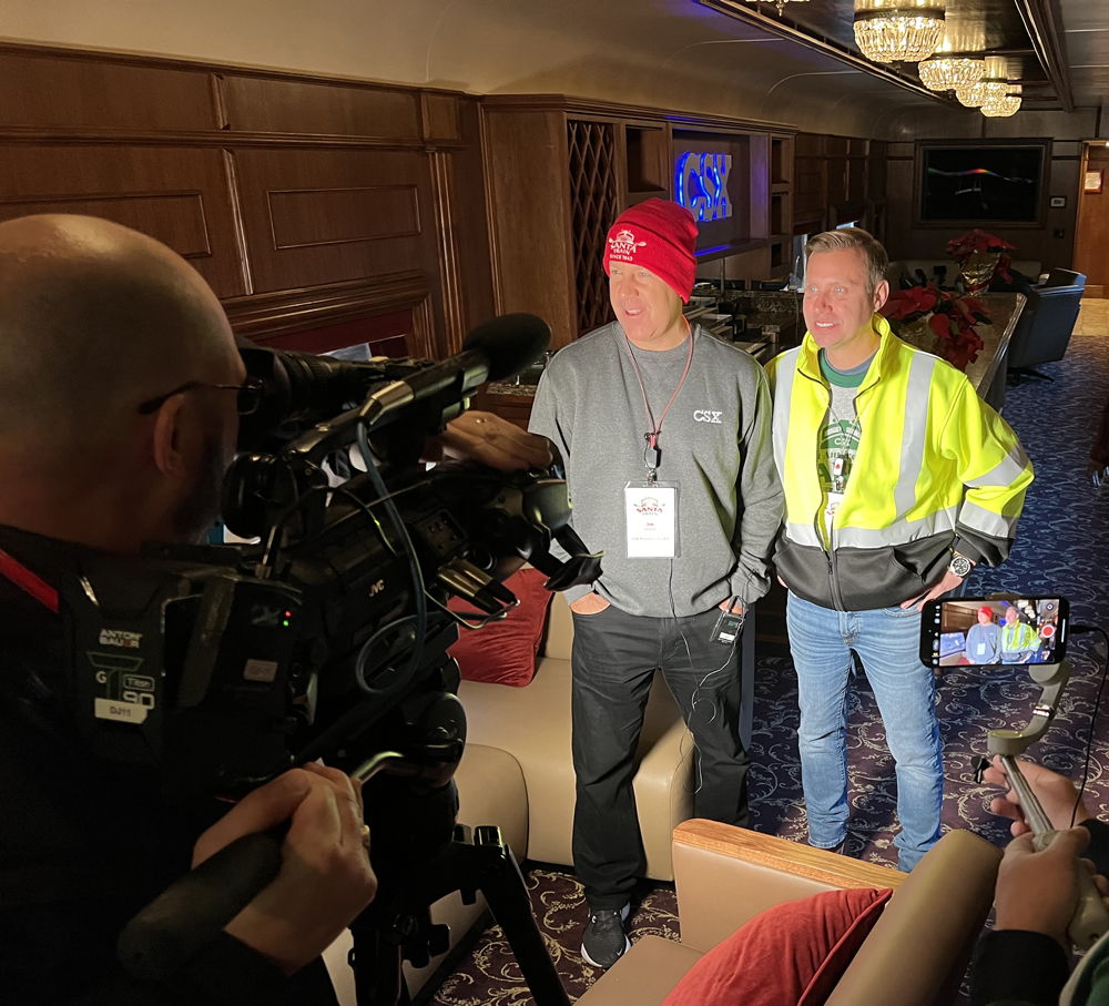 Two men standing in front of TV camera