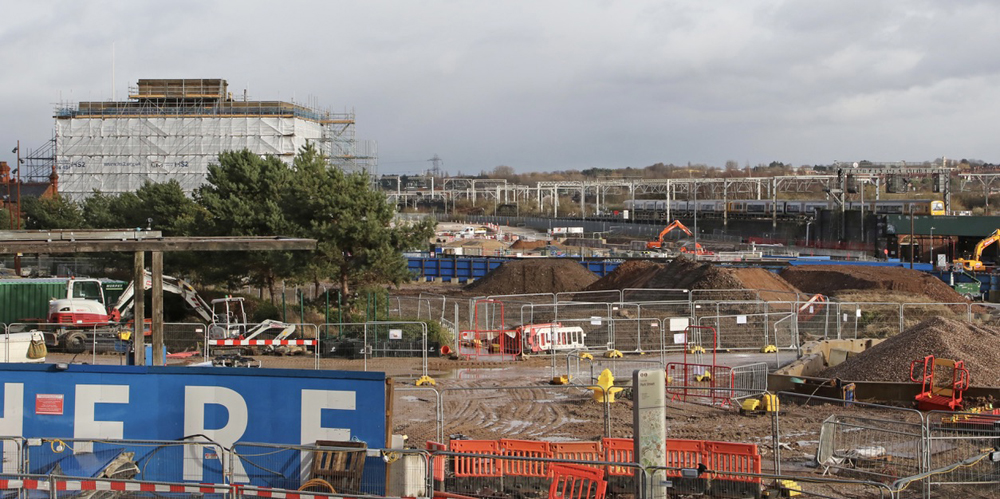 Construction site with rail line in distance