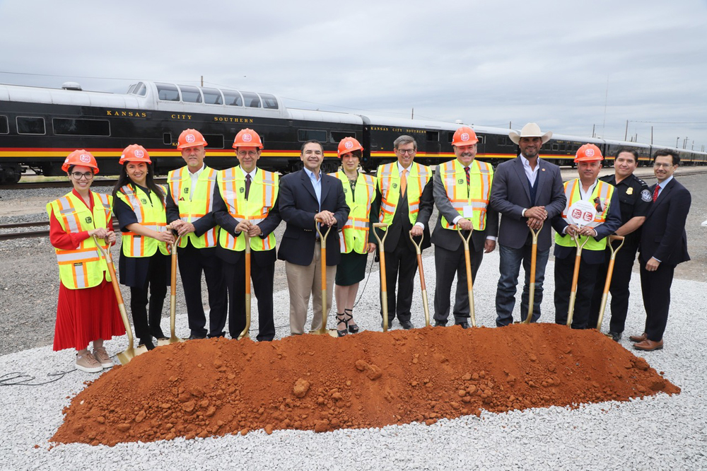 12 people posed with shovels