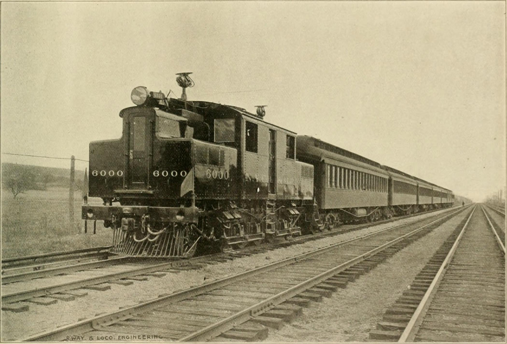 Sepia-tone photo of electric locomotive with passenger train