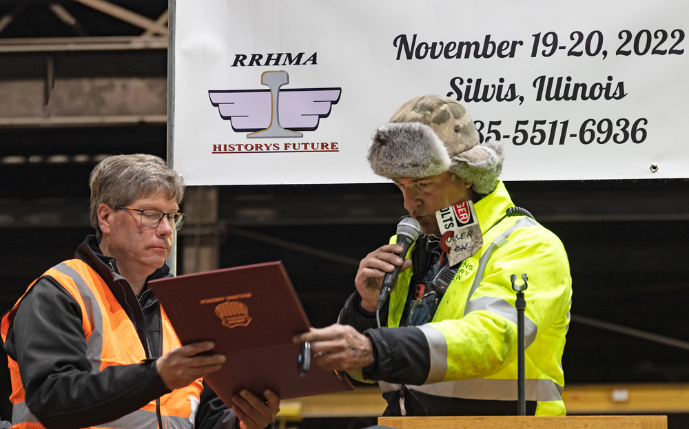 Two men holding document