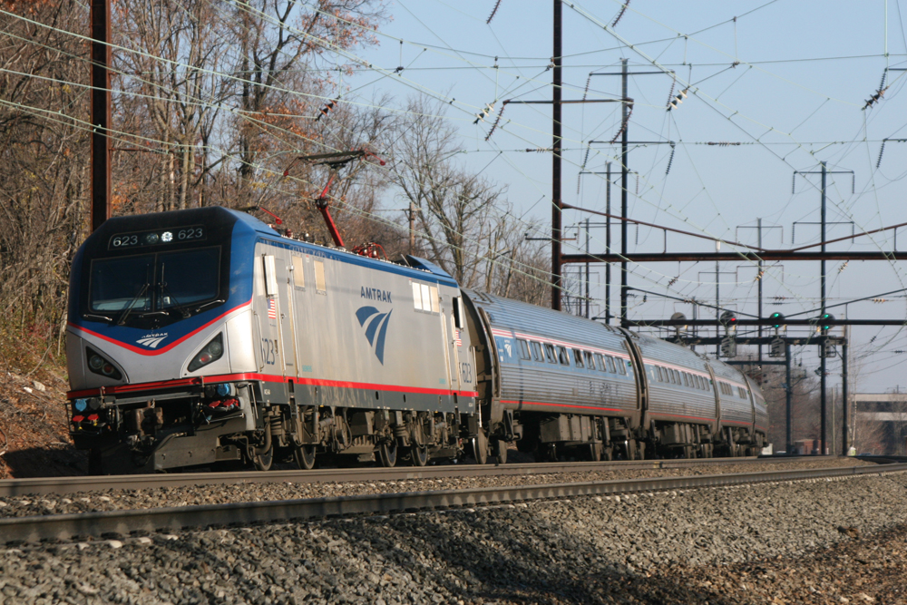 Electric locomotive and passenger cars rounding curve