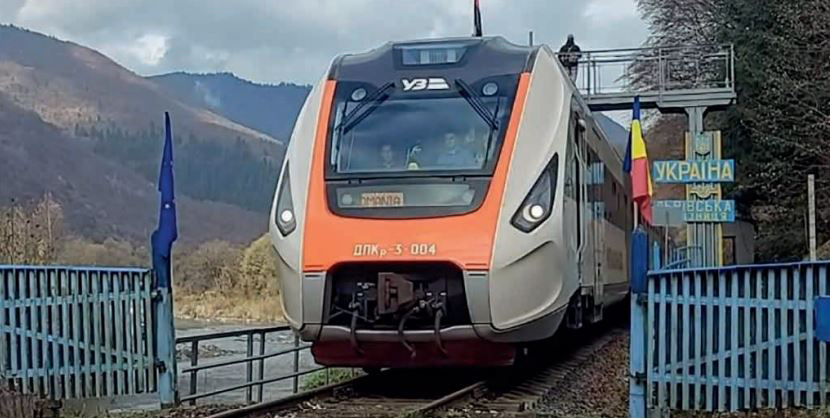 Streamlined train at border fence