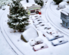snowy scene of model auto garage on garden railway