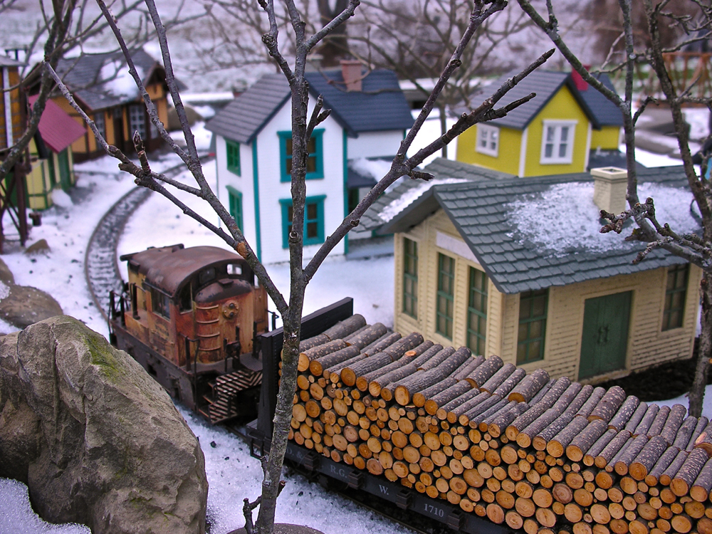 model diesel with load of logs on garden railway