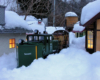 model locomotive with snowplow clearing the tracks on garden railway