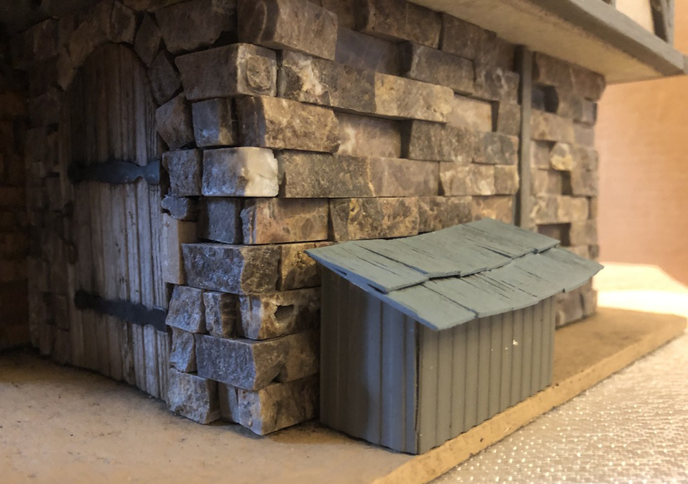 model storage box next to cottage