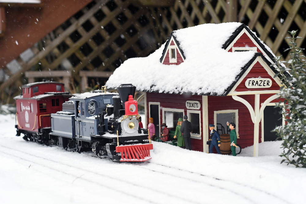 snowy scene with model locomotive and station