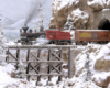 A Heisler pulling a boxcar emerges from a tunnel onto a wood trestle above a snowy gorge