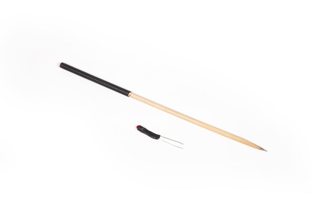 Handy tools for DCC wiring projects: Heat shrink tubing is shown on an LED light and a couple pick.