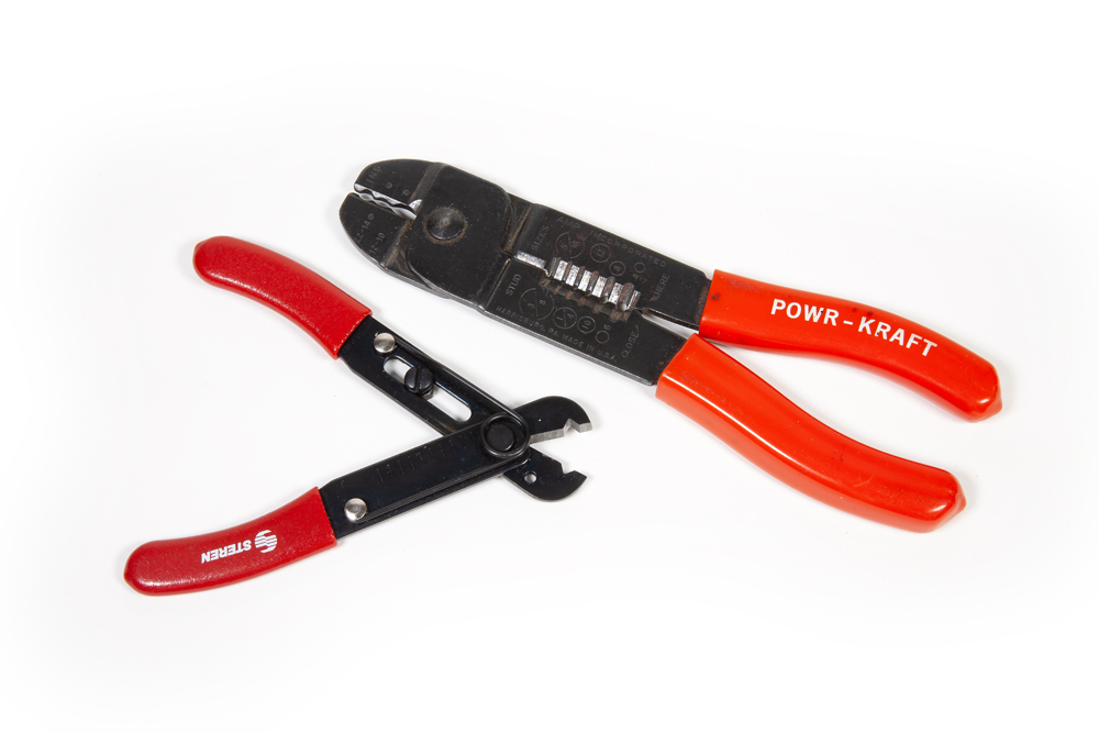 Handy tools for DCC wiring projects: A pair of wire cutters with red handles against a white background.