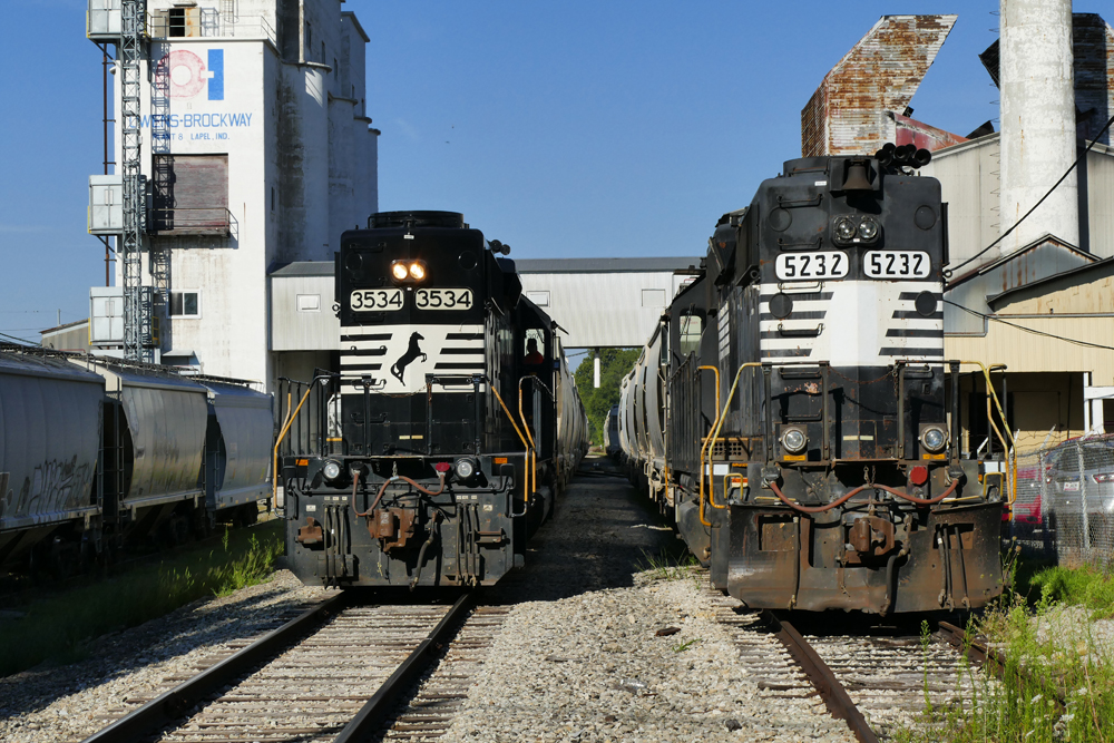 two trains black and white on tracks