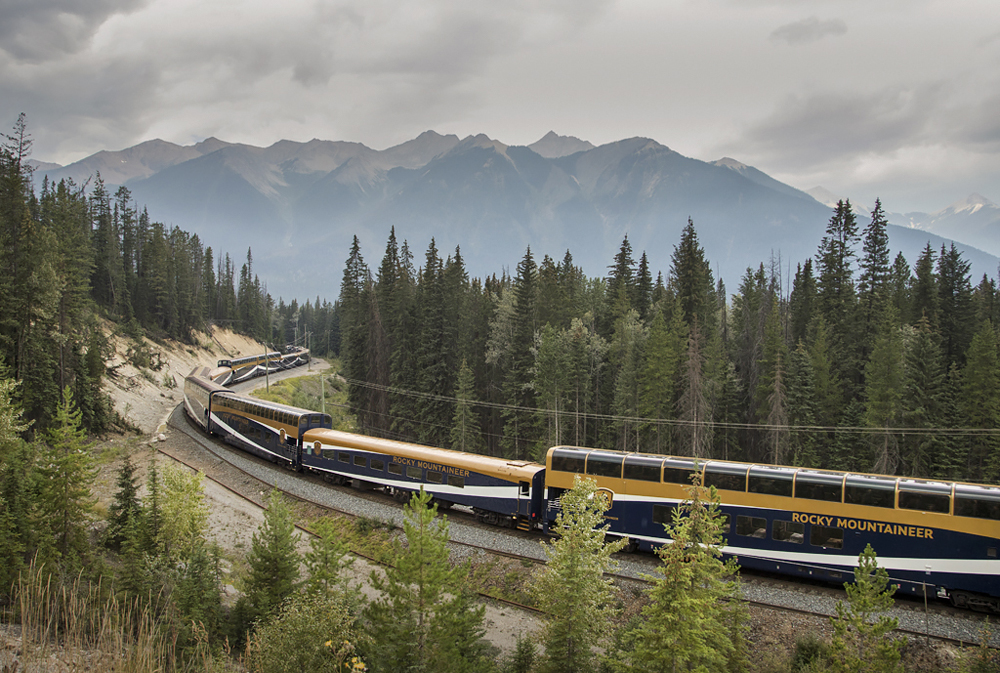 train passing mountains on rail