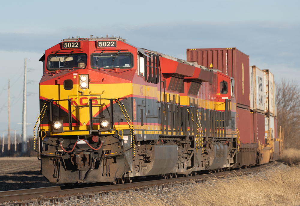 Two red, yellow, and black locomotives on freight train