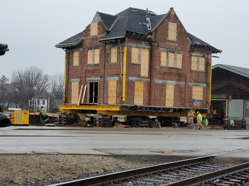 Boarded-up two-story building lifted off ground