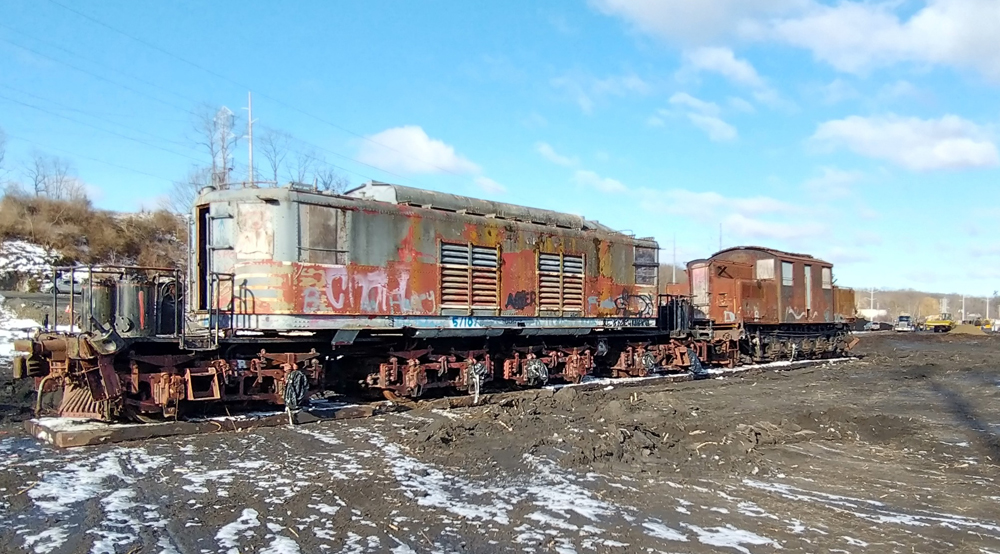 Two graffiti-covered electric locomotives on platform