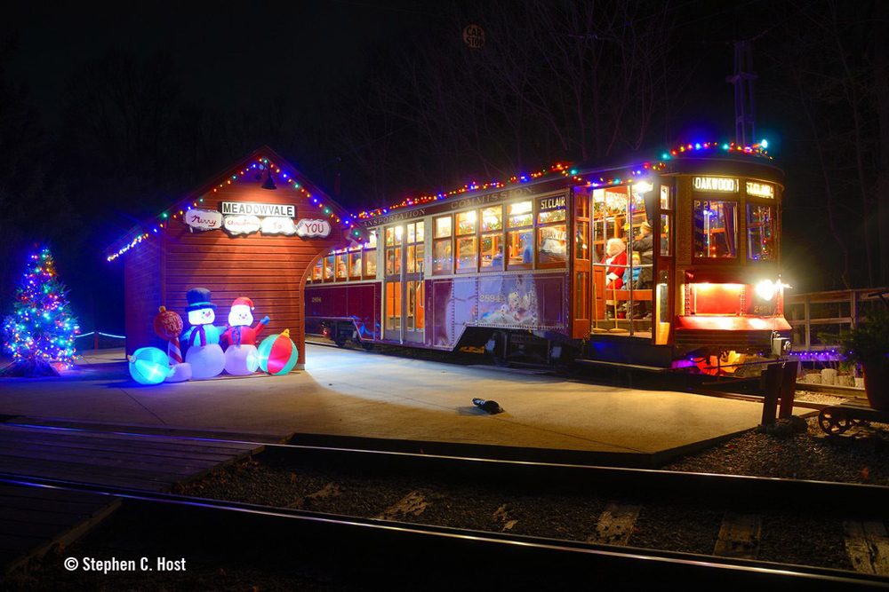 Streetcar decorated with holiday lights at station