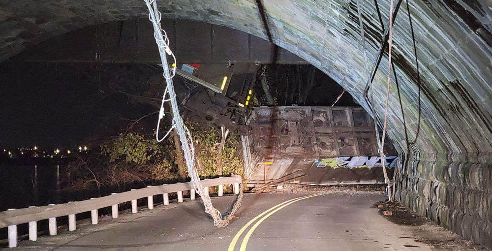 Derailed railroad car on roadway in night photo