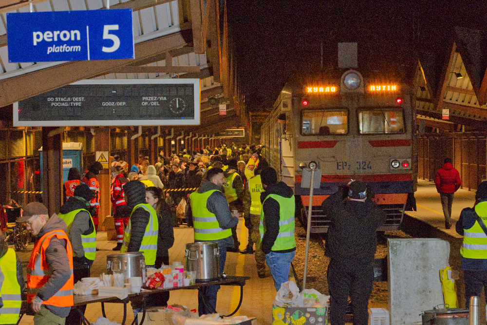 Train at crowded station at night