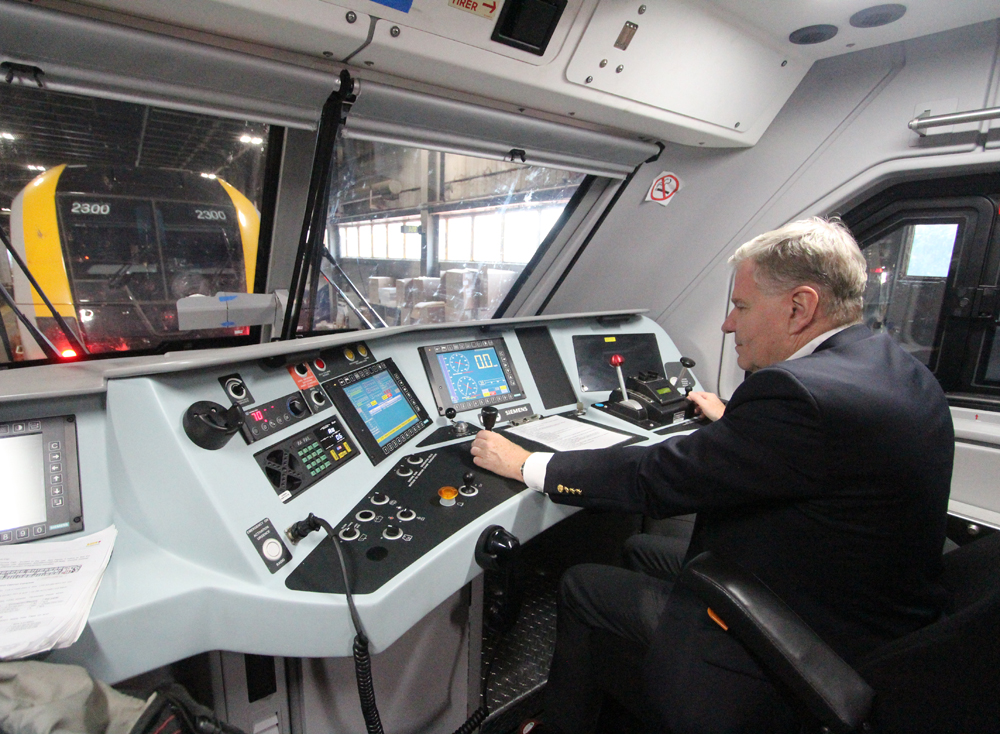 Man at control desk of passenger cab car