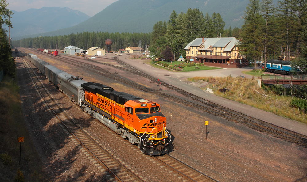 Passenger train passes inn building