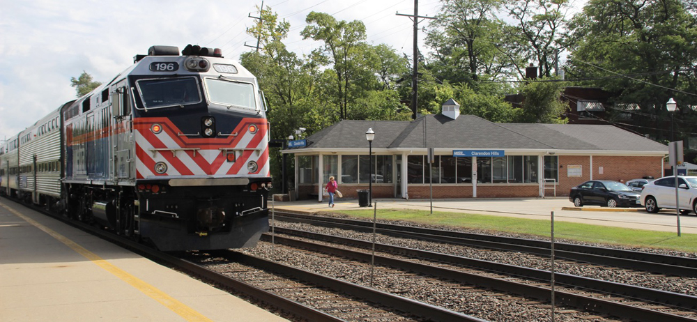 Commuter train with station in background