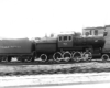 Steam locomotive with mid-boiler cab in profile view