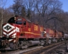 Three red diesel locomotives on freight train in curve