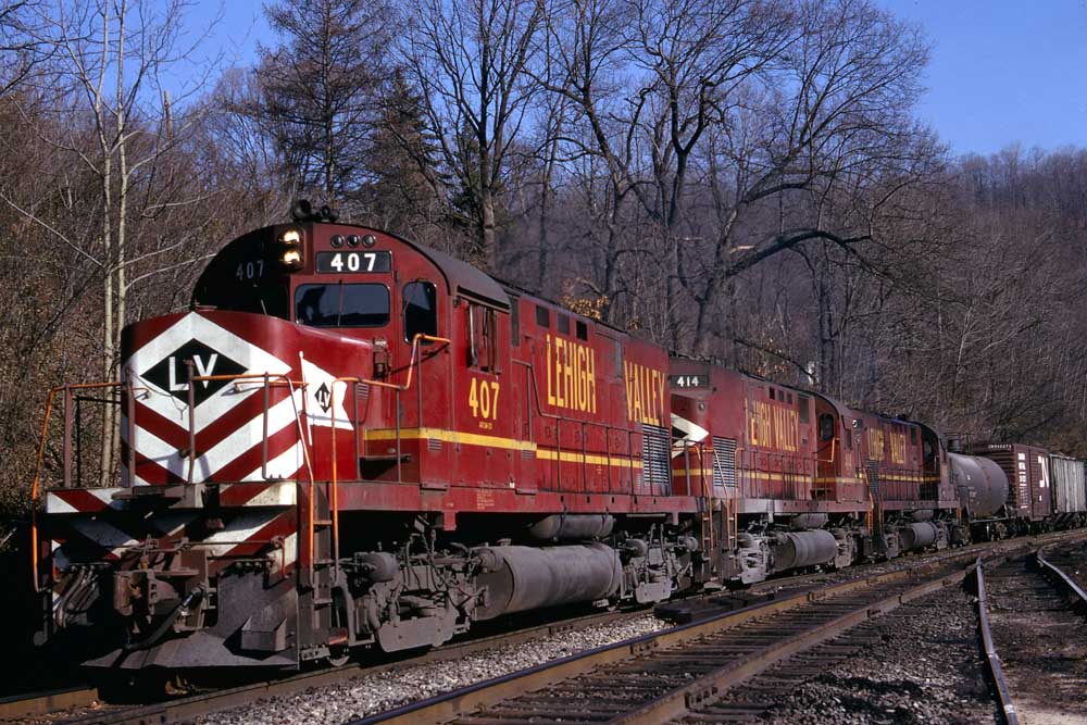 Three red diesel locomotives on freight train in curve