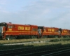 Four shiny new red-and-yellow diesel locomotives
