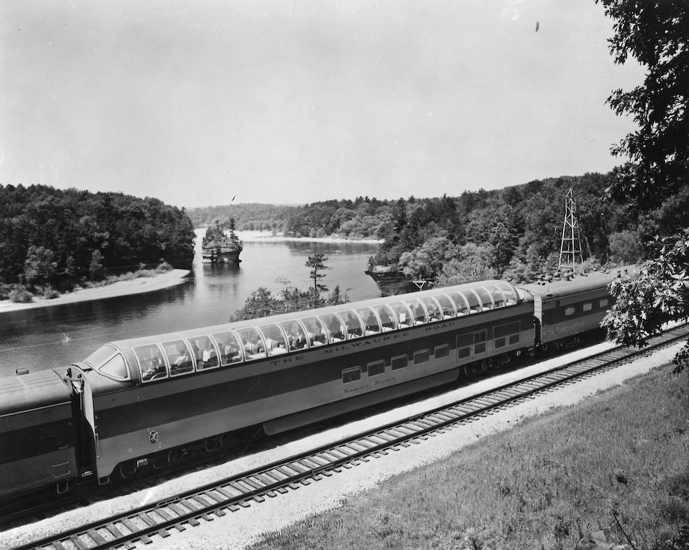 Dome car passing by river in Wisconsin.