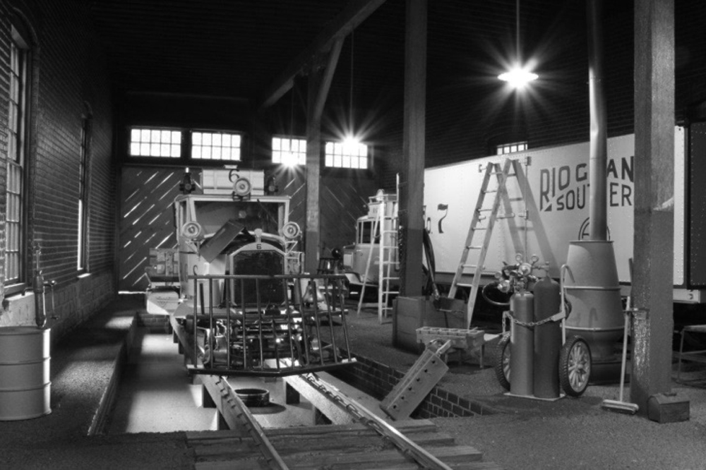black and white photo of inside of model roundhouse