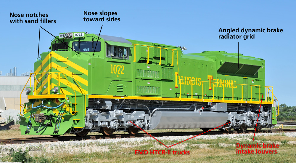 A bright green modern EMD diesel is seen in a nose-on three-quarters view
