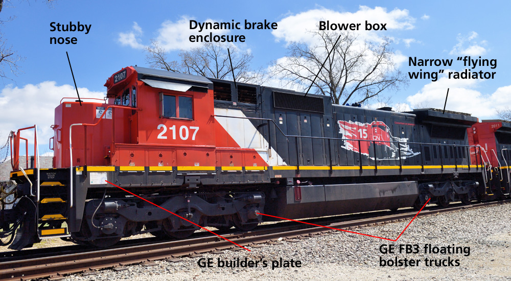 A black, white, and red GE Dash-8 locomotive in a three-quarters nose view