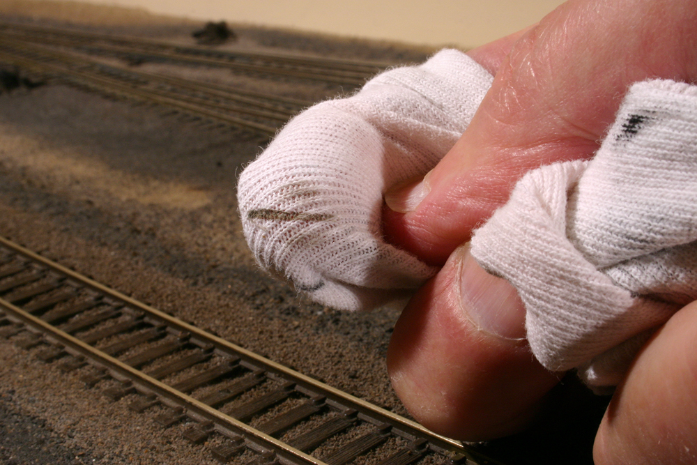A white cloth with a black streak after being wiped down rail
