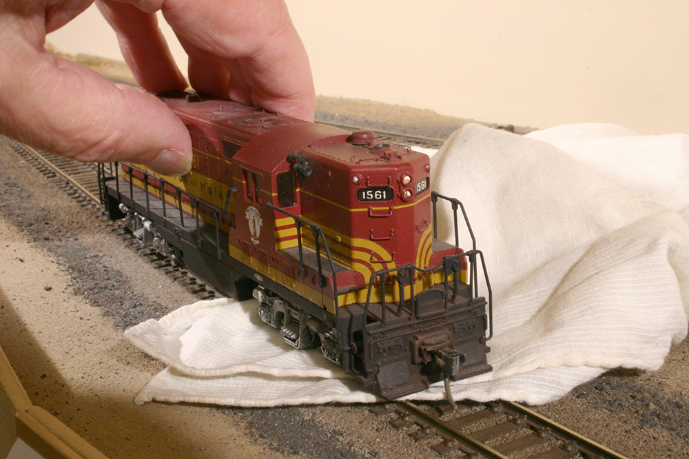 A diesel locomotive’s front truck is being cleaned while the rear truck gets power