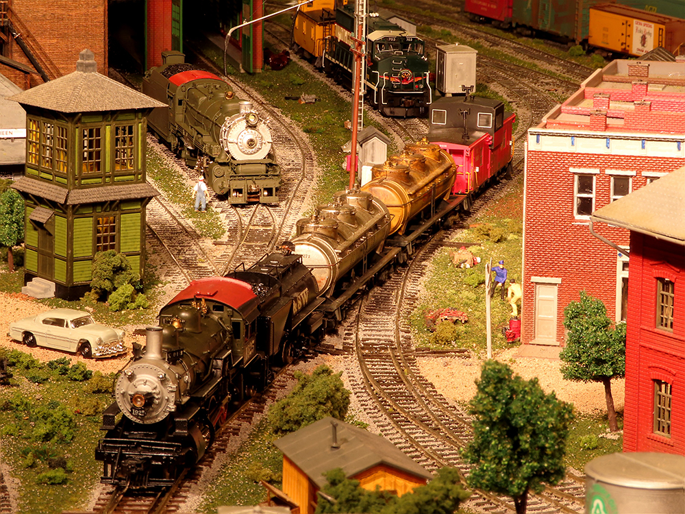 Steam locomotive with train crossing layout at an angle