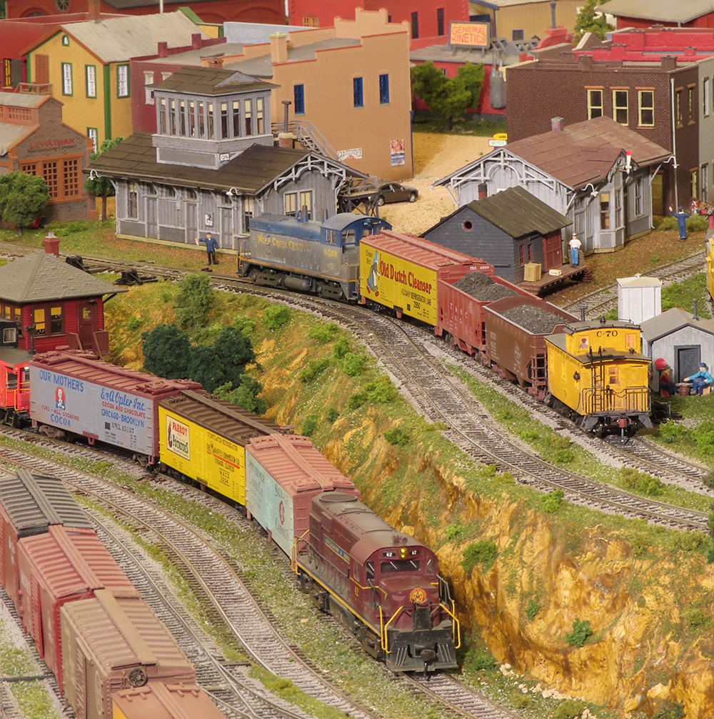 two trains on two different levels on a layout