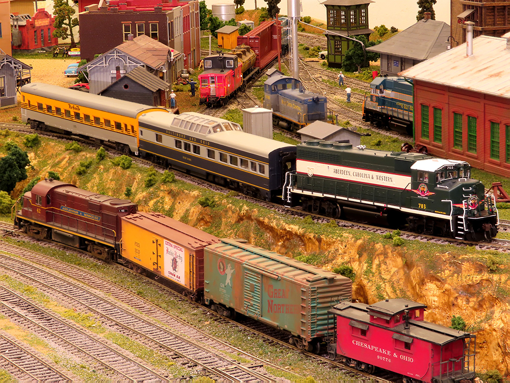 Two trains passing each other on model train layout