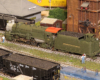 model steam locomotive next to coaling tower