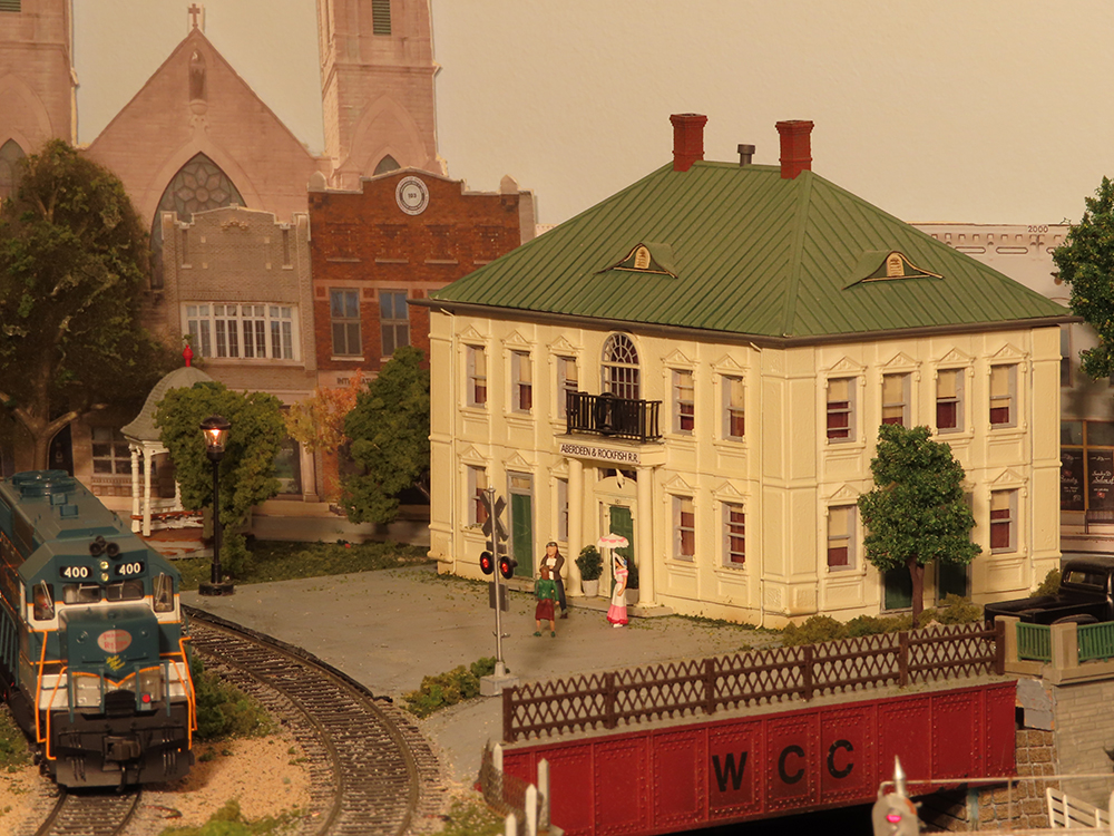 model diesel locomotive with large structure on model train layout