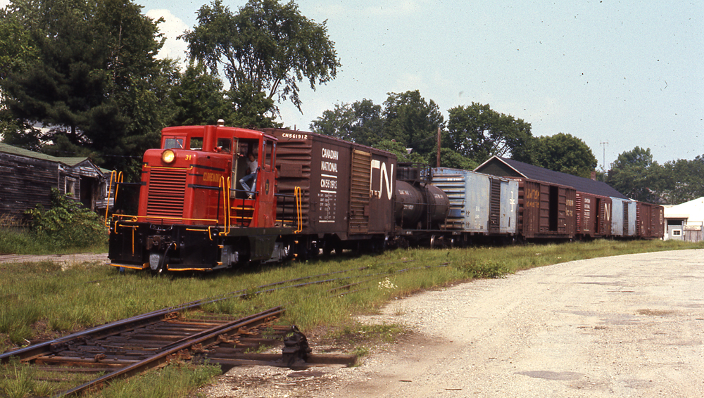 Photo of center-cab locomotive with seven car train