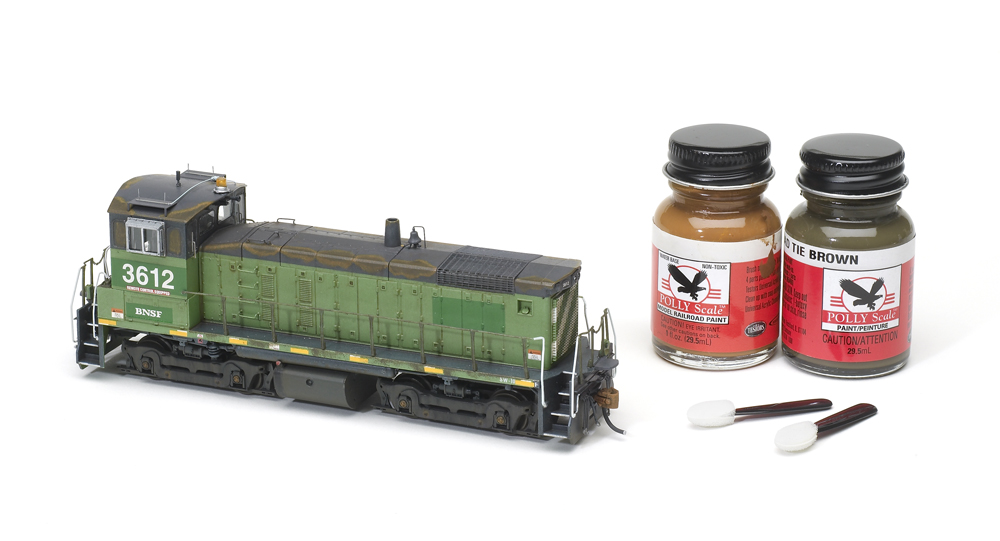 Using cosmetic applicators for weathering: An image of a model locomotive and paints.
