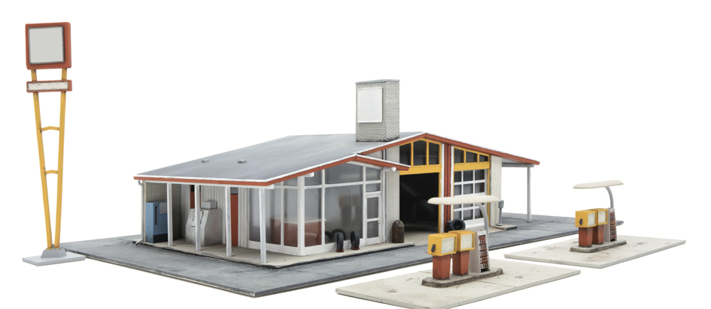 Vintage gas station: A vintage model gas station in white with yellow and red details is shown against a white background