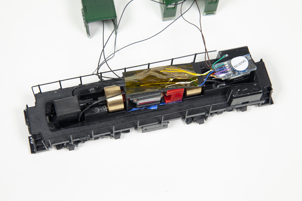 A locomotive shell with multiple colors of wires coming from a decoder