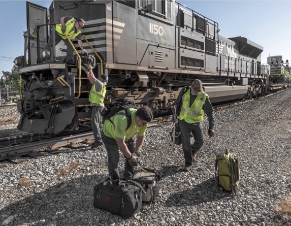 Crew members climbing on or off locomotive